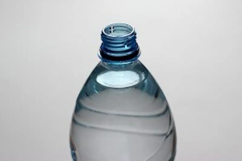 there is a bottle of water sitting on a table