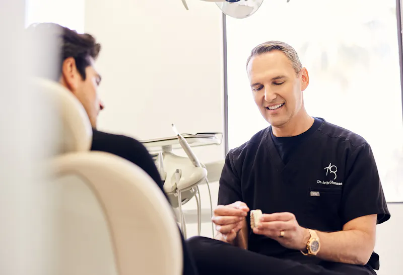Dr. Glosman, a cosmetic dentist in Beverly Hills, speaking with a male patient