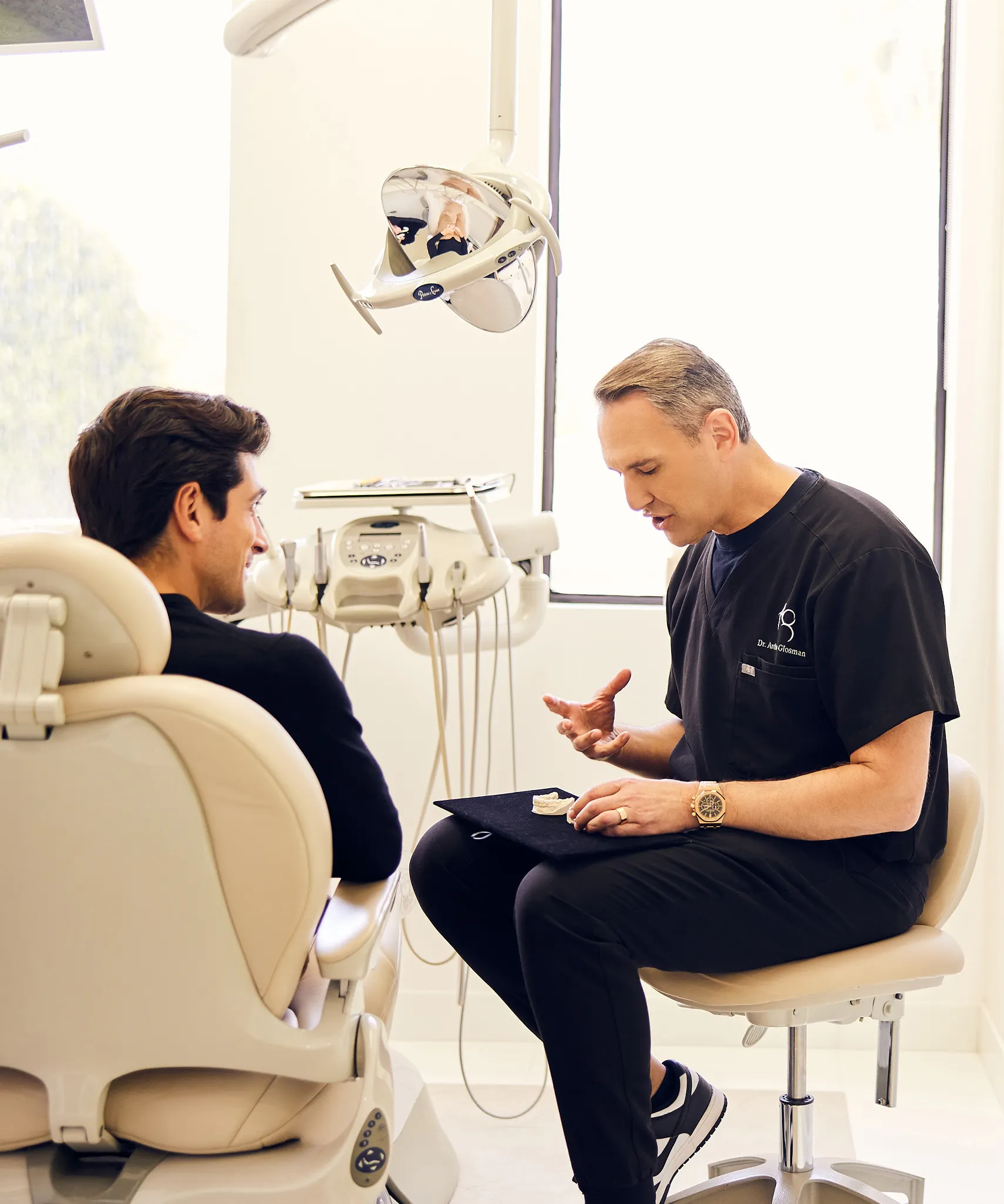 Dr. Glosman speaking with a male patient
